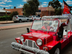 Santa arrives in town in a Moke